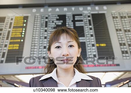 Stock Photo - Portrait of a businesswoman at an airport. Fotosearch