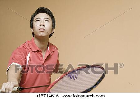 Stock Photograph - Close-up of a young man playing badminton. Fotosearch