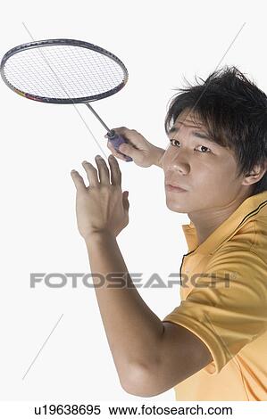 Stock Photography - Close-up of a young man playing badminton. Fotosearch