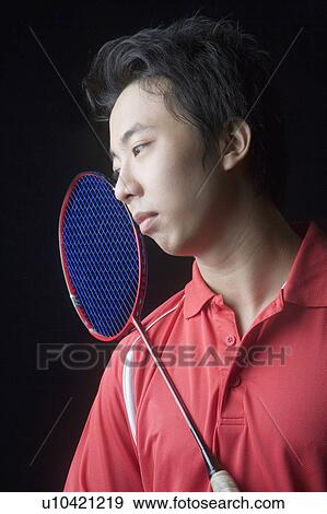 Stock Photo - Close-up of a young man with a badminton racket. Fotosearch