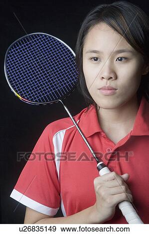 Stock Photo - Close-up of a young woman holding a badminton racket. Fotosearch