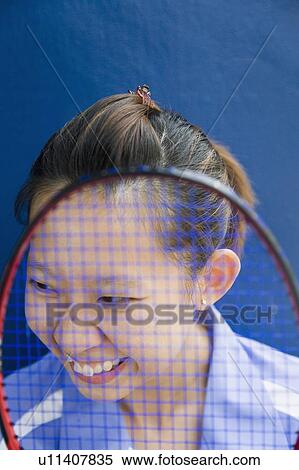 Close-up of a young woman with a badminton racket and smiling View Large Photo Image Stock Photography - Close-up of a young woman with a badminton racket and smiling. Fotosearch