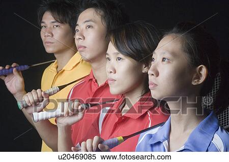 Close-up of two young women and two young men standing side by side with badminton rackets View Large Photo Image Stock Photography - Close-up of two young women and two young men standing side by side with badminton rackets. Fotosearch
