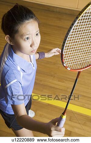 High angle view of a young woman playing badminton View Large Photo Image Stock Photo - High angle view of a young woman playing badminton. Fotosearch