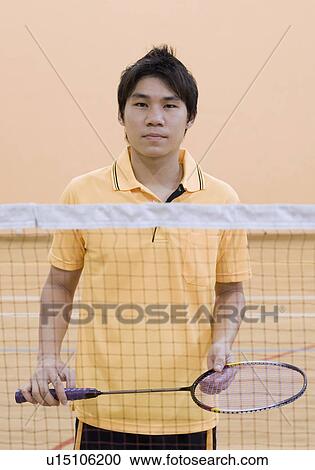 Portrait of a young man holding a badminton racket View Large Photo Image Stock Image - Portrait of a young man holding a badminton racket. Fotosearch