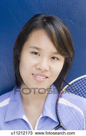 Portrait of a young woman with a badminton racket and smiling View Large Photo Image Stock Image - Portrait of a young woman with a badminton racket and smiling. Fotosearch