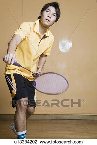 Young man playing badminton View Large Photo Image Stock Image - Young man playing badminton. Fotosearch