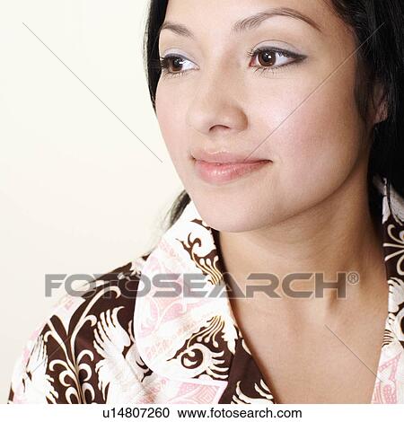 Stock Image - Close-up of a young woman looking away. Fotosearch