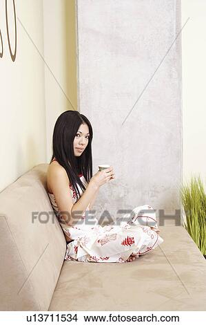 Picture - Portrait of a young woman holding a cup. Fotosearch