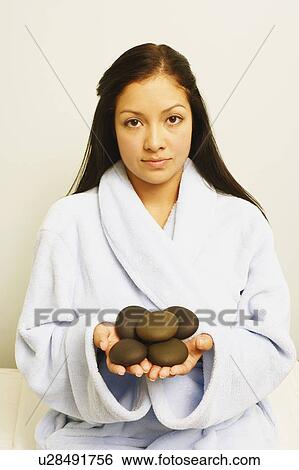 Portrait of a young woman holding stones View Large Photo Image Stock Photograph - Portrait of a young woman holding stones. Fotosearch