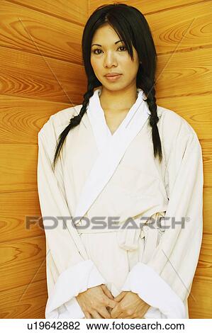 Stock Image - Portrait of a young woman standing. Fotosearch