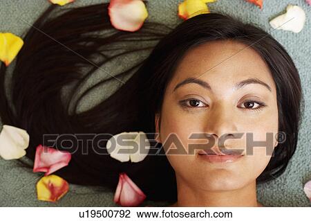 Portrait of a young woman with petals around her View Large Photo Image Stock Image - Portrait of a young woman with petals around her. Fotosearch