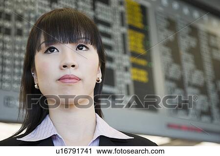 Close-up of a businesswoman at an airport View Large Photo Image Stock Image - Close-up of a businesswoman at an airport. Fotosearch