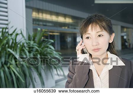 Stock Photo - Close-up of a businesswoman using a mobile phone. Fotosearch