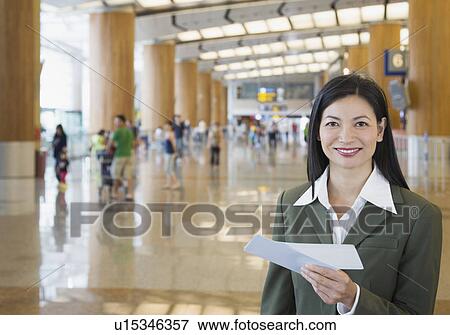 Portrait of a businesswoman holding an airplane ticket View Large Photo Image Stock Photo - Portrait of a businesswoman holding an airplane ticket. Fotosearch