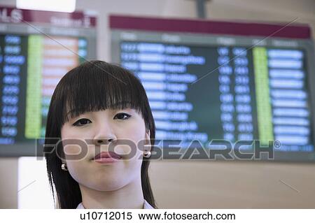 Portrait of a businesswoman in front of an arrival departure board View Large Photo Image Stock Photography - Portrait of a businesswoman in front of an arrival departure board. Fotosearch