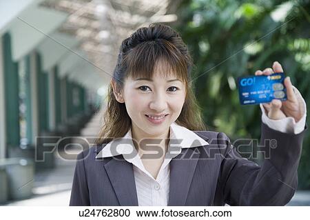 Portrait of a businesswoman showing a credit card View Large Photo Image Stock Image - Portrait of a businesswoman showing a credit card. Fotosearch