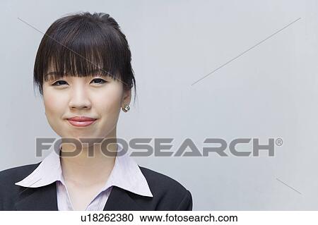 Stock Image - Portrait of a businesswoman smirking. Fotosearch