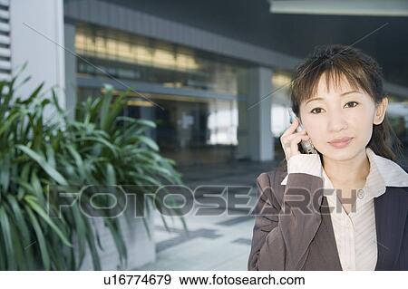 Stock Photo - Portrait of a businesswoman talking on a mobile phone. Fotosearch