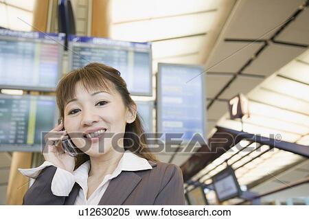 Portrait of a businesswoman talking on a mobile phone View Large Photo Image Stock Photography - Portrait of a businesswoman talking on a mobile phone. Fotosearch