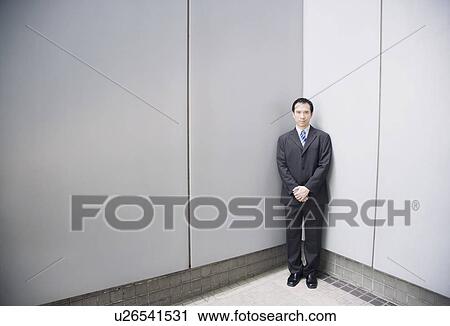 Businessman standing in a corner with his hands clasped View Large Photo Image Stock Image - Businessman standing in a corner with his hands clasped. Fotosearch