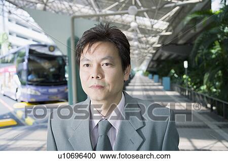 Close-up of a businessman looking away View Large Photo Image Stock Image - Close-up of a businessman looking away. Fotosearch
