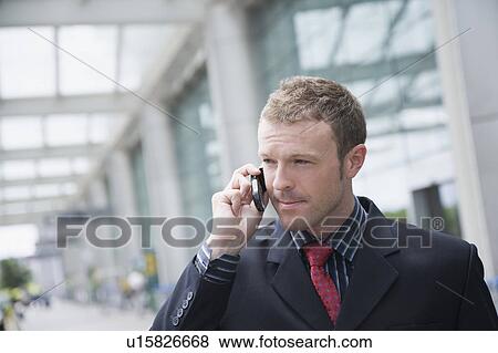 Stock Photo - Close-up of a businessman talking on a mobile phone. Fotosearch