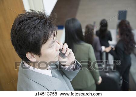 High angle view of a businessman talking on a mobile phone View Large Photo Image Stock Photo - High angle view of a businessman talking on a mobile phone. Fotosearch