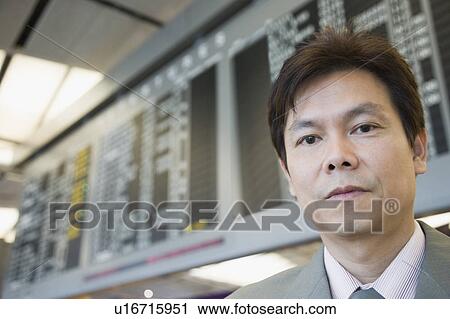 Stock Image - Portrait of a businessman at an airport. Fotosearch