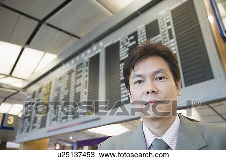 Portrait of a businessman at an airport View Large Photo Image Stock Image - Portrait of a businessman at an airport. Fotosearch