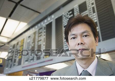 Stock Photo - Portrait of a businessman at an airport. Fotosearch