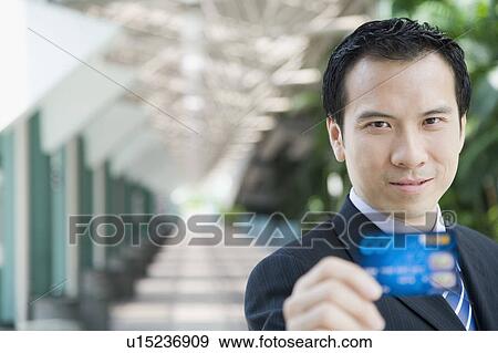 Portrait of a businessman showing a credit card View Large Photo Image Stock Photo - Portrait of a businessman showing a credit card. Fotosearch