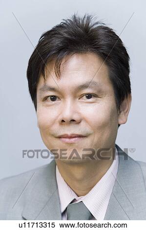 Portrait of a businessman smirking View Large Photo Image Stock Photography - Portrait of a businessman smirking. Fotosearch