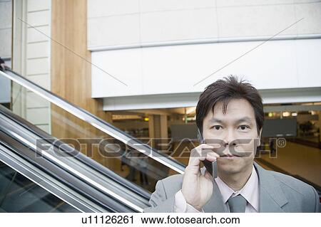 Stock Image - Portrait of a businessman talking on a mobile phone. Fotosearch