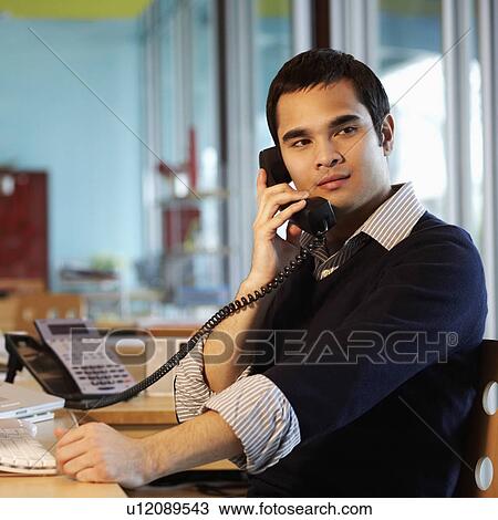 Side profile of a businessman talking on the telephone in an office View Large Photo Image Stock Image - Side profile of a businessman talking on the telephone in an office. Fotosearch