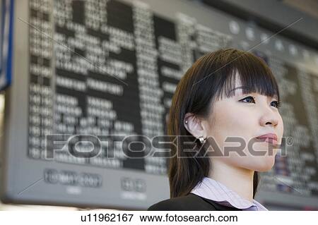 Stock Photo - Close-up of a businesswoman at an airport. Fotosearch