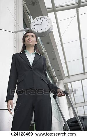 Low angle view of a businesswoman waiting at an airport lounge View Large Photo Image Stock Photo - Low angle view of a businesswoman waiting at an airport lounge. Fotosearch