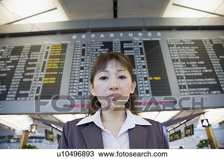 Stock Image - Portrait of a businesswoman at an airport. Fotosearch