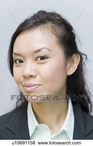 Stock Photo - Portrait of a businesswoman smirking. Fotosearch