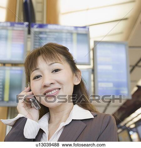 Stock Photo - Portrait of a businesswoman talking on a mobile phone. Fotosearch