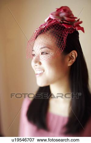 Stock Photo - Close-up of a young woman wearing a headdress. Fotosearch
