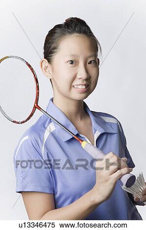 Portrait of a young woman holding a badminton racket and a shuttlecock View Large Photo Image Stock Photography - Portrait of a young woman holding a badminton racket and a shuttlecock. Fotosearch