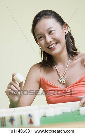 Young woman playing with blocks and smiling View Large Photo Image Stock Image - Young woman playing with blocks and smiling. Fotosearch