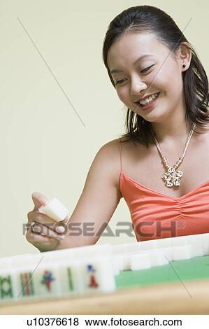 Young woman playing with blocks and smiling View Large Photo Image Stock Photo - Young woman playing with blocks and smiling. Fotosearch