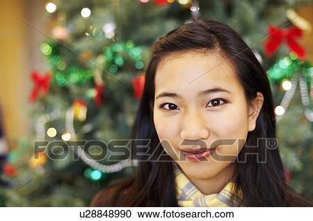 Stock Image - Portrait of a young woman grinning. Fotosearch