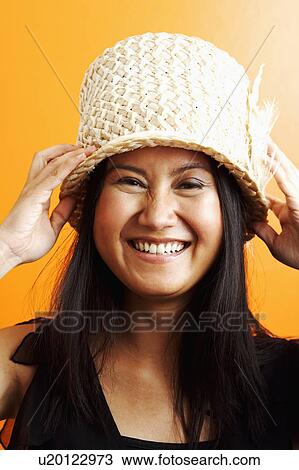 Stock Image - Portrait of a young woman smiling. Fotosearch