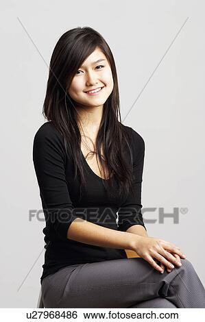 Portrait of a young woman smiling View Large Photo Image Stock Photograph - Portrait of a young woman smiling. Fotosearch