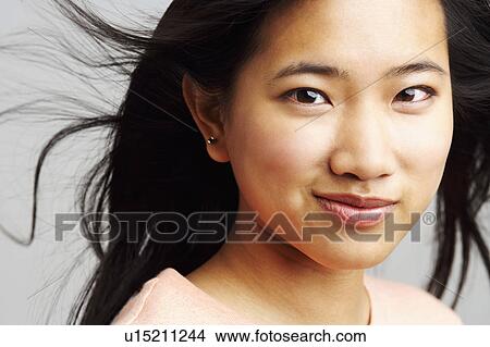 Picture - Portrait of a young woman smirking. Fotosearch