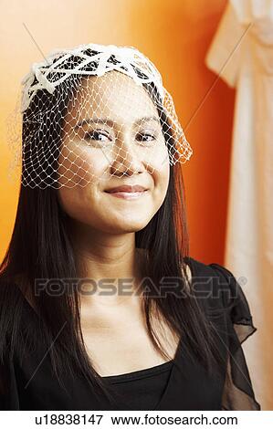 Stock Photo - Portrait of a young woman wearing a veil. Fotosearch