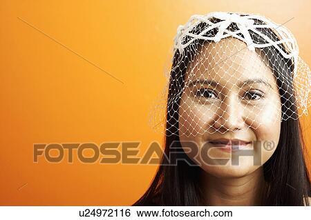 Stock Photograph - Portrait of a young woman wearing a veil. Fotosearch